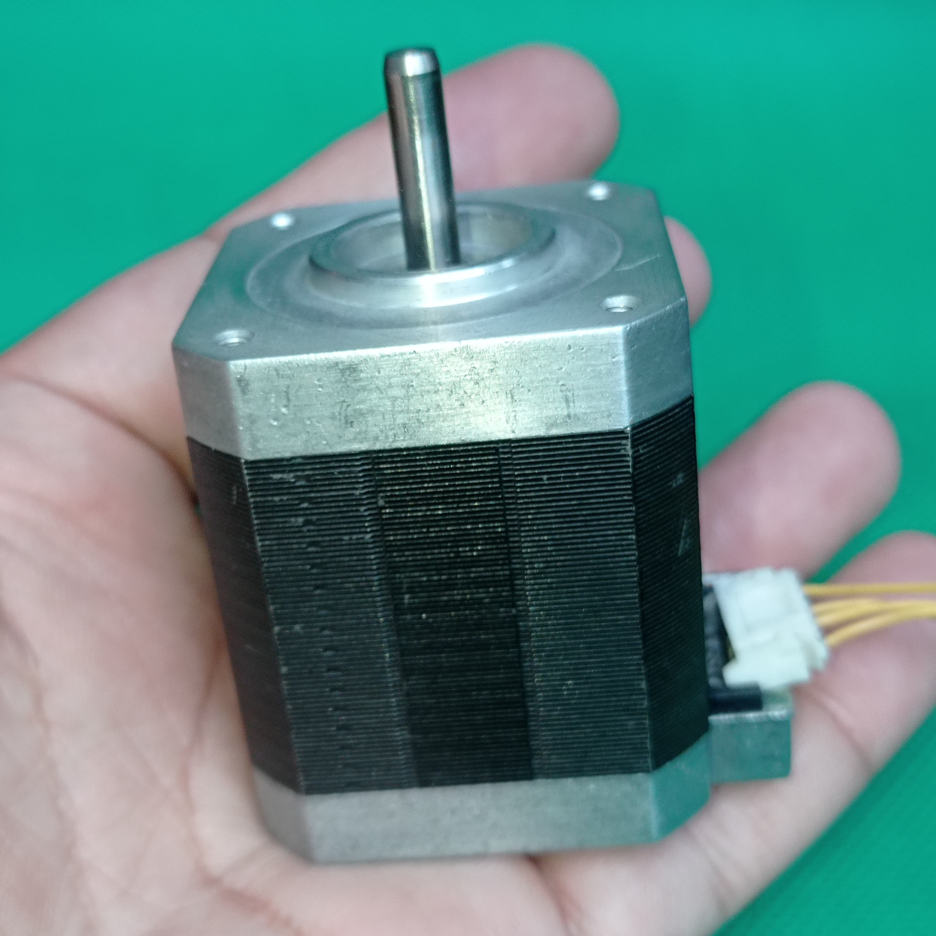 Shinano Kenshi STP-42D4042 2A 1.8 Degree Per Step 0.53nm Stepper Motor - a silver metal body, a cylindrical shaft, and a white electrical connector with wires.