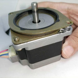 Shock Absorber Stepper Vibration Damper For NEMA23 Stepper Motor - shown attached to a silver and black stepper motor with a four-wire connector.