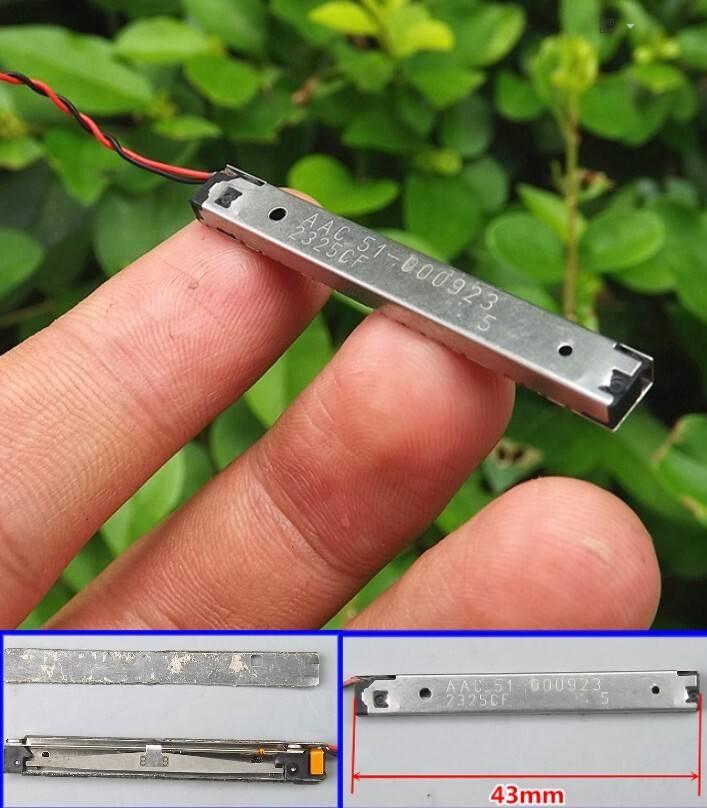 Shock Sensor Precision Vibration Sensor - a thin rectangular metal component with red and black wires, shown in a hand and with dimension markings.