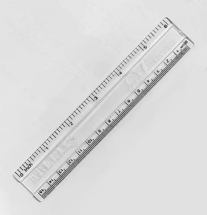 Signature Artist Scale 6 Inches - a clear, transparent plastic ruler with black printed inch and centimeter markings on a white background.