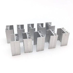 Silver Aluminium To 220 Heat Sink - a group of eight identical silver-coloured, finned metal heat sinks arranged on a white surface.