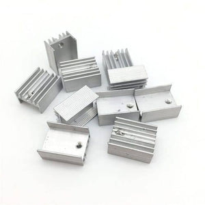 Silver Aluminium To 220 Heat Sink - a collection of multiple silver-coloured aluminium heat sinks with mounting holes arranged on a white surface.