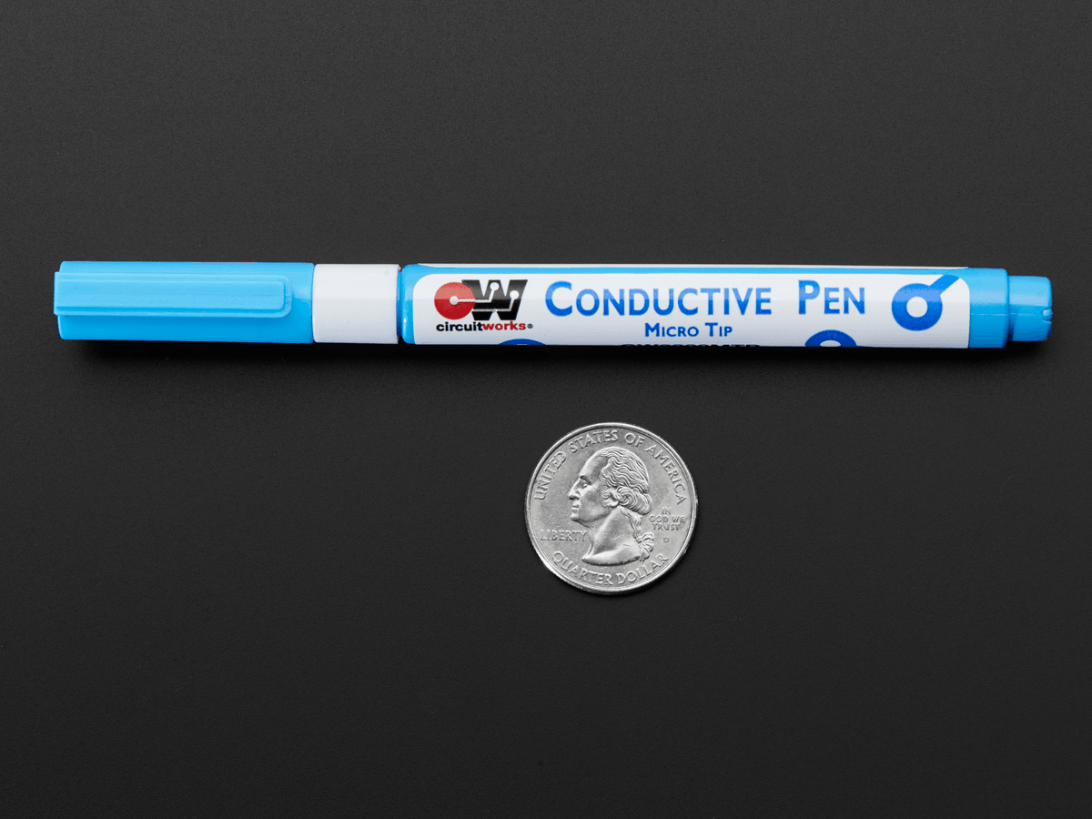 Silver Conductive Ink Pen CW2000 - shown as a blue micro tip marker placed next to a US quarter coin for scale on a black background.