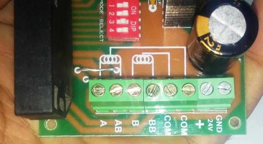 Sine Wave STK672-050 3amp Unipolar 6 Wires Stepper Motor Driver - a close-up of a green circuit board with a red DIP switch and screw terminal connectors.