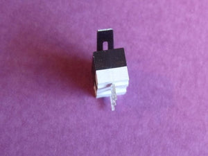 Small Microswitch / Limit Switch - a close-up side view of a black and white rectangular switch body with a metal actuator lever and three metal terminal pins.