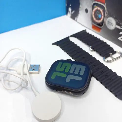 Smart Watch T900 Ultra 2.09 Inch Big Display Bluetooth Calling Series 8 With All Sports Features & Health Tracker - Smart Watch Ultra Infinite Display - a black watch body with a digital display, a black silicone strap, and a white magnetic charging cable next to its box.