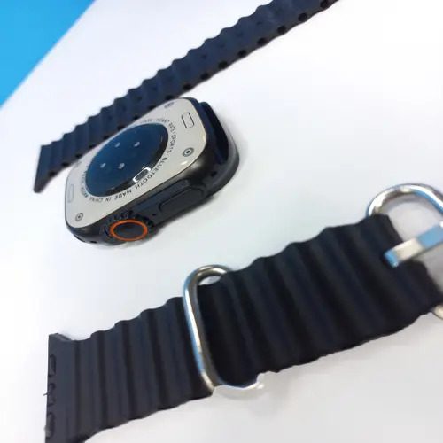 Smart Watch T900 Ultra 2.09 Inch Big Display Bluetooth Calling Series 8 With All Sports Features & Health Tracker - Smart Watch Ultra Infinite Display - the black casing with a side button and orange-accented dial, alongside two black silicone watch straps on a white surface.