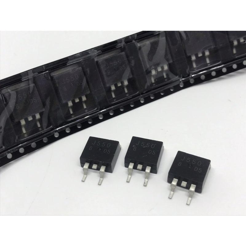 SMD IRF9540 MOSFET - P-Channel Power MOSFET TO263-3 MOSFET -100V -23A - three black TO-263 packaged components placed in front of a black plastic carrier tape strip containing identical units.