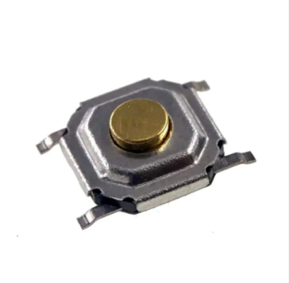 SMD Tactile Switch, 4x4x1.5mm - a close-up view of a small square silver-coloured metal tactile switch with a round gold-coloured button in the center.