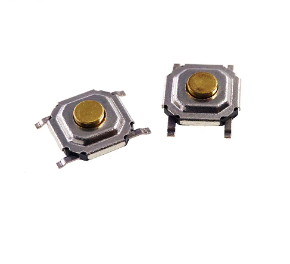 SMD Tactile Switch, 4x4x1.5mm - 4x4x1.5mm, showing two small square metal tactile switches with gold-coloured circular buttons and four protruding mounting pins.