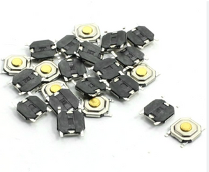 SMD Tactile Switch, 4x4x1.5mm - 4x4x1.5mm, shown as a pile of small, square, black and silver electronic push-button switches with gold-colored circular centers.