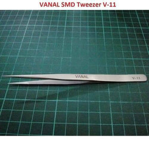 SMD Tweezer Vanal v 11 For Positioning Components - a silver-colored, pointed metal tweezer lying horizontally on a green cutting mat.