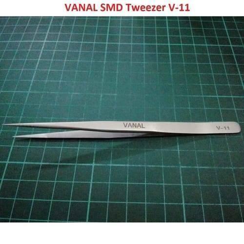 SMD Tweezer Vanal v 11 For Positioning Components - a silver-colored, pointed metal tweezer lying horizontally on a green cutting mat.