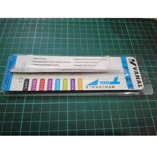SMD Tweezer Vanal v 11 For Positioning Components - shown in its original retail blister packaging, featuring a silver metal body resting on a green cutting mat.
