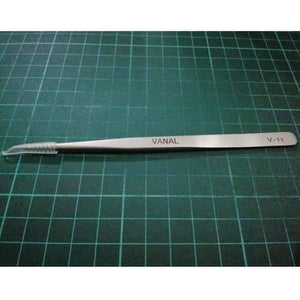 SMD Tweezer Vanal v 11 For Positioning Components - a silver-coloured metal tool with a protective plastic tip cover, lying horizontally on a green cutting mat.