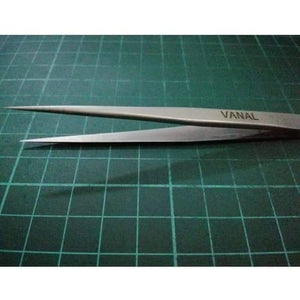 SMD Tweezer Vanal v 11 For Positioning Components - a silver-coloured metal precision tool with pointed tips, resting on a green grid cutting mat.