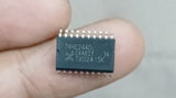 SN74HC244 SMD IC - held between fingers, showing a black rectangular surface-mount integrated circuit with 20 pins and the text 74HC244D printed on top.