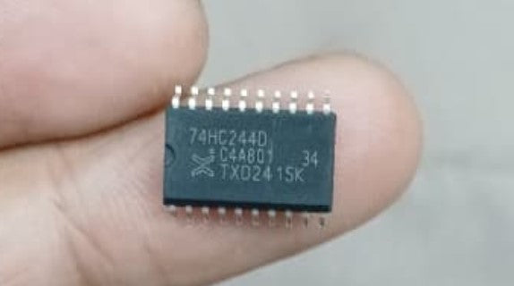 SN74HC244 SMD IC - held between fingers, showing a black rectangular surface-mount integrated circuit with 20 pins and the text 74HC244D printed on top.