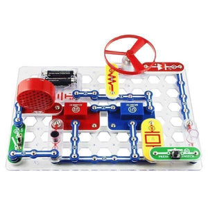 Snap Circuits Jr Sc-100 Electronics Discovery Kit - a partially assembled circuit board with batteries, a red fan, switches, and blue modules.
