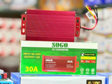 SOGO 30A DC Converter | 48-72V to 12V Step Down Voltage Regulator - a red rectangular voltage regulator with wires, sitting on top of its green and white product packaging box.