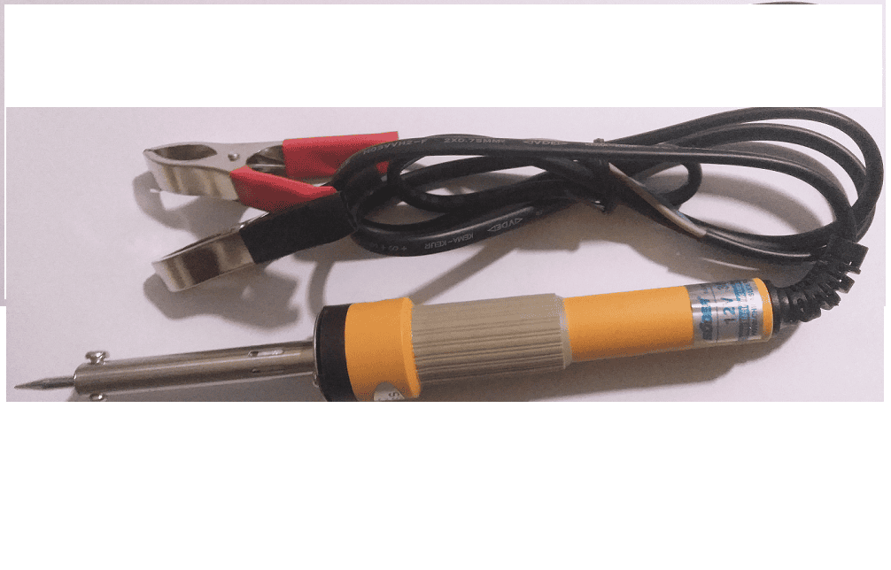 Soldering Iron 12V 60W - a yellow and grey handheld soldering iron with a metal tip and a black power cable ending in red and black alligator clips.