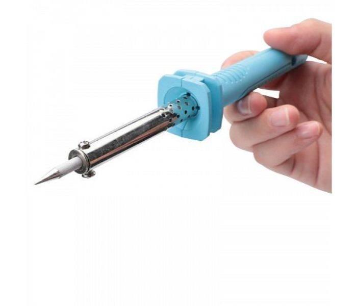 Soldering Iron 60watt - shown being held by a hand, featuring a light blue plastic handle and a metallic heating element with a pointed tip.