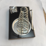 Soldering Iron Stand Holder - a black rectangular base, a coiled metal spring holder, a circular tray, and a small bag of included screws.
