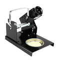 Soldering Iron Stand LTJ217 Good Quality - a black metal stand with a coil-style iron holder, a wire handle, and a circular tray with a cleaning sponge.