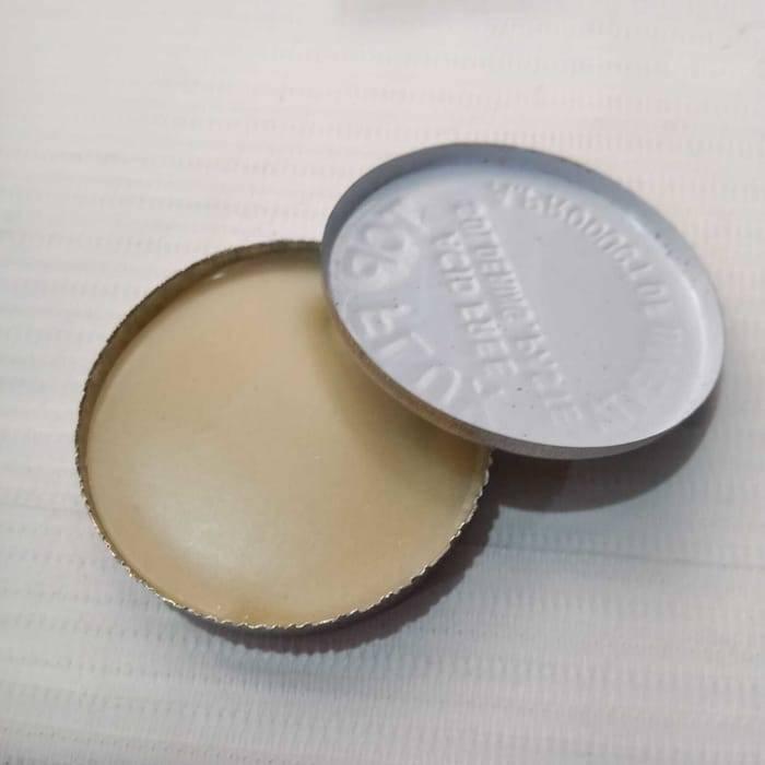 Soldering Paste - round metal container with the lid removed, showing the pale yellow paste and the underside of the white metal lid.