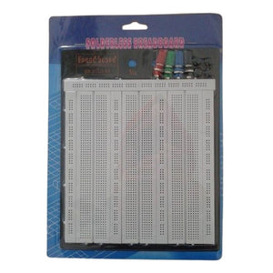 Solderless Bread Board BB-3T5D-01 - a white multi-section breadboard with four colored binding posts, shown inside its original retail blister packaging.