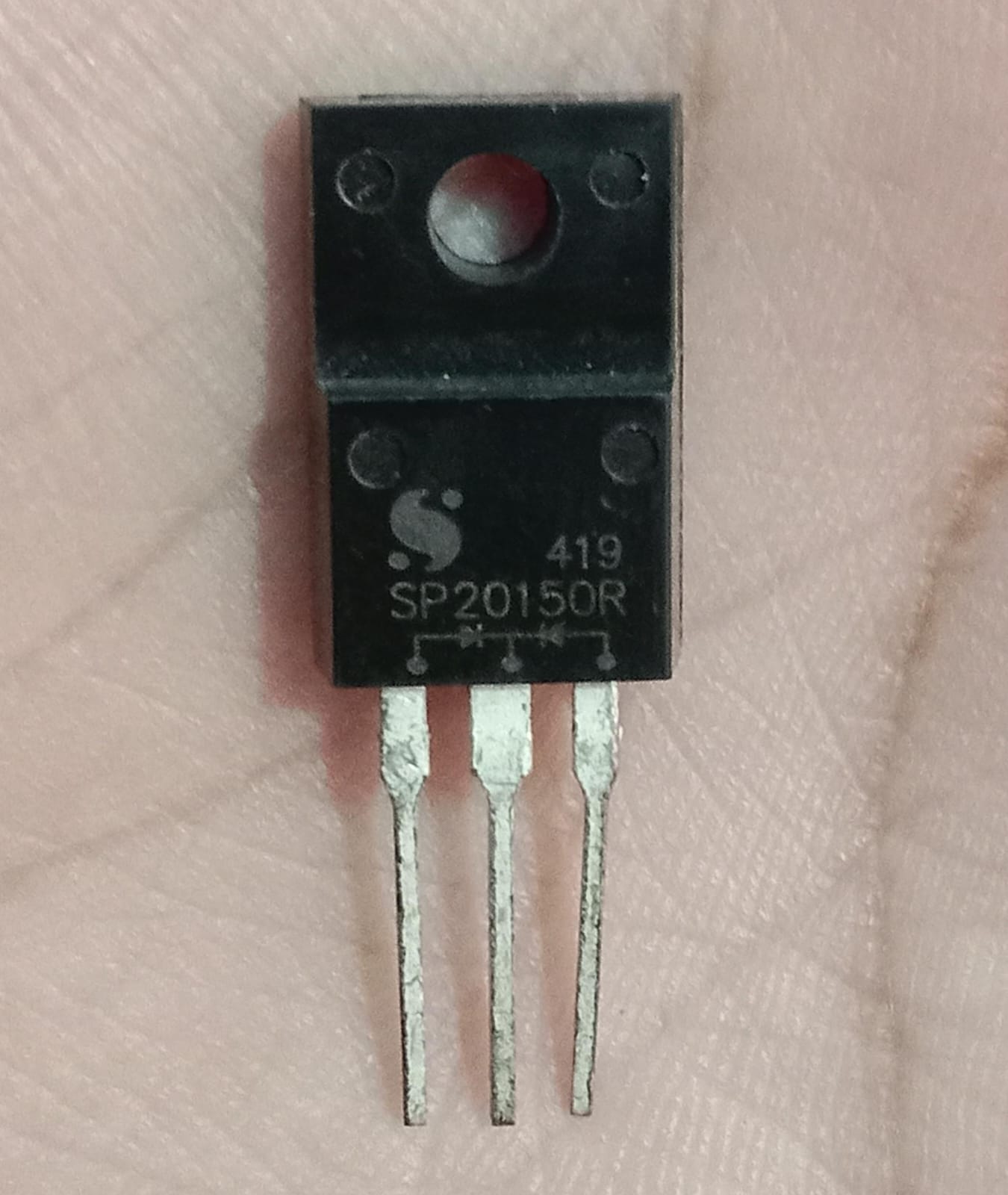 SP20150R 20A 150V Dual Schottky Barrier Rectifier Diode (TO-220F) Used - with three metal pins, shown in a close-up against a skin-toned background.
