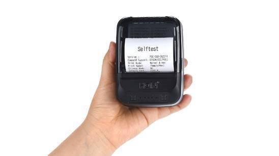 Speed-x BT450M Mini Portable Bluetooth+USB Printer 58mm - a black device printing a white paper slip with the text "Selftest".