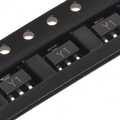 SS8050 NPN Transistor SOT-23 SMD Y1 for Arduino ESP32 Pakistan - close-up view of black electronic transistors marked with Y1 arranged in a plastic carrier tape for surface mounting.