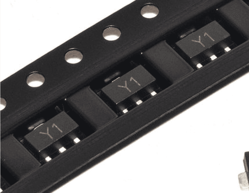 SS8050 NPN Transistor SOT-23 SMD Y1 for Arduino ESP32 Pakistan - close-up view of black electronic transistors marked with Y1 arranged in a plastic carrier tape for surface mounting.