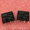 Ssr Solid State Relay Ssr G3mb-202P - two black rectangular relay modules with four metal pins each, resting on a textured red foam surface.