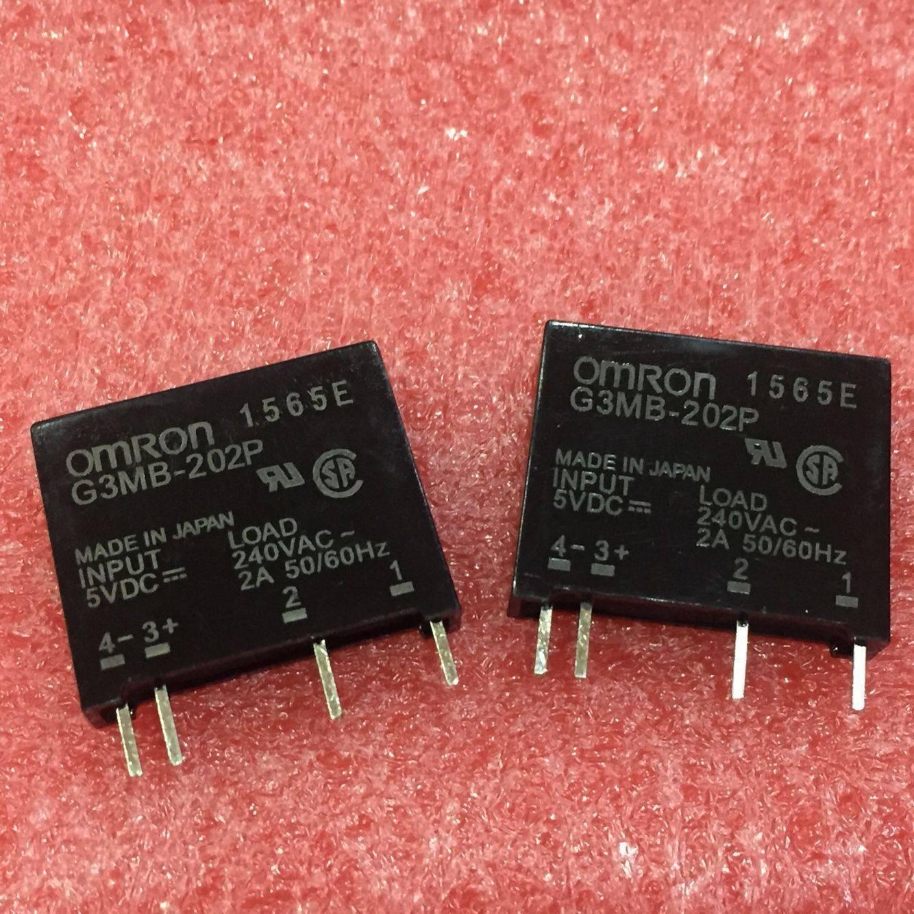 Ssr Solid State Relay Ssr G3mb-202P - two black rectangular relay modules with four metal pins each, resting on a textured red foam surface.