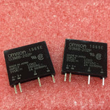 Ssr Solid State Relay Ssr G3mb-202P - two black rectangular relay modules with four metal pins each, resting on a textured red foam surface.