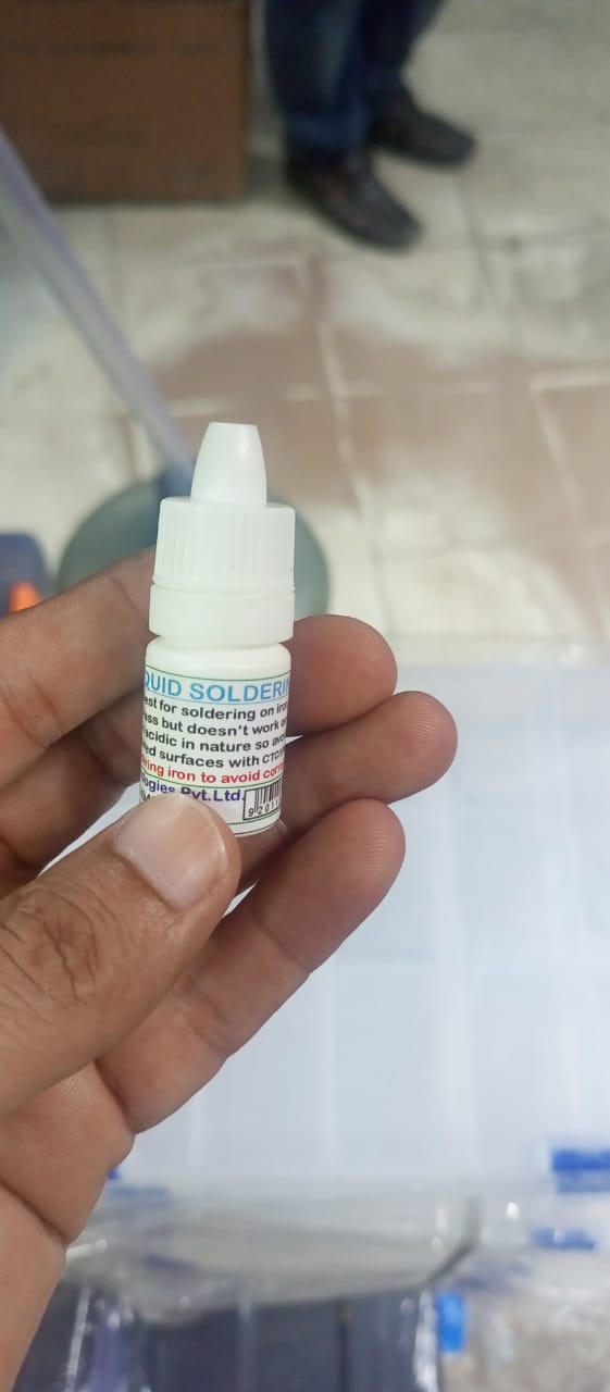 Stainless Steel Flux Soldering Stainless Steel Liquid Solder Soldering Liquid Solution - Liquid Soldering FluxL - Liquid Paste - a small white plastic squeeze bottle held in a hand showing the printed label with product usage instructions.