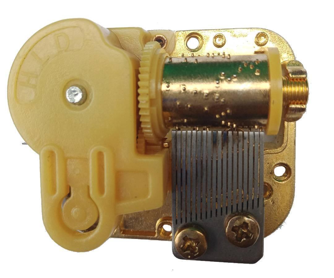 STEM Toy 18 Note Mechanical Music Box Music Movement Set - a gold-toned metal mechanism with a yellow plastic gear housing and a metal comb.
