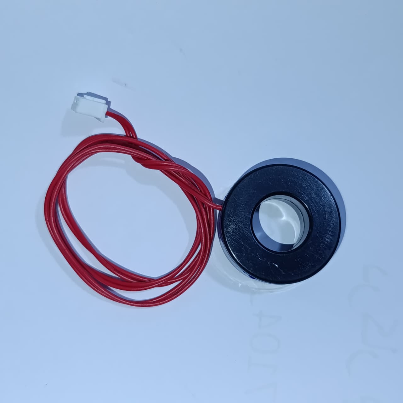 STM Sinewave Inverter Drive Module Grid Sharing With CT - a black circular current transformer sensor with a red two-wire cable and white connector.