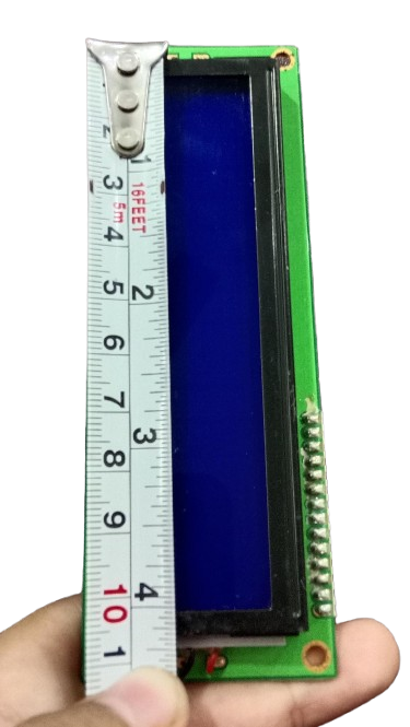 Stock Lot 16x2 Blue/Green LCD in USED CONDITION - shown with a tape measure placed against its length to display its physical dimensions.