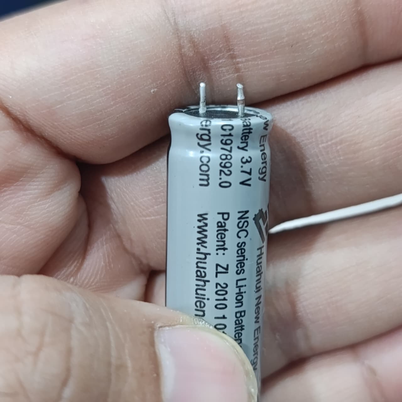 Stock Lot 3.7V 800mAh Lithium Battery 14mm x 50mm 2-Pin Rechargeable (Li-ion Cylindrical Cell) - a close-up of a grey cylindrical Li-ion cell with two metal pins and printed text.