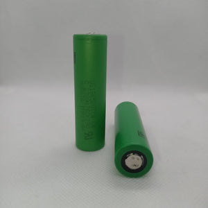 Stock Lot US18650UTC4 3.7V 2000mA 18650 Li-ion Rechargeable Battery – High-Capacity Power Cell for Flashlights, Laptops, and Power Tool - two green cylindrical cells shown with one standing upright and one lying horizontally on a white surface.