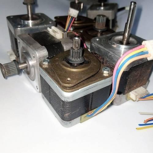 Stock Lot Used A4988 Compatible NEMA 17 Stepper Motor NEMA17 - a collection of used silver and black square motors with attached metal shafts, gears, and multi-colored wiring harnesses.