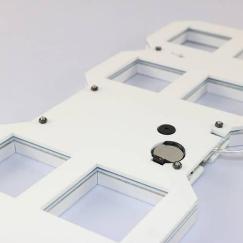 Stylish & Unique Electronic Desk Clock Vst-883-white - the white rear casing with a circular battery compartment, a small speaker, and screws.