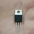 SVG104R5NT N-Channel Power MOSFET - a black three-pin electronic component with a metal heat sink tab, held against a human palm.