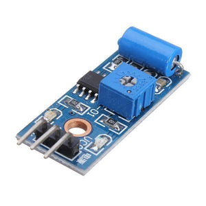 Sw-420 Vibration Sensor - a blue cylindrical sensor, a blue adjustable potentiometer, a black IC, and a three-pin header on a blue PCB.