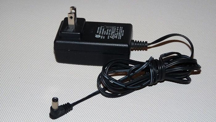 Switching Power Supply Adapter S012BU2400050 24V 400mA - a black wall-plug power adapter with an attached cord and a right-angle DC barrel connector.