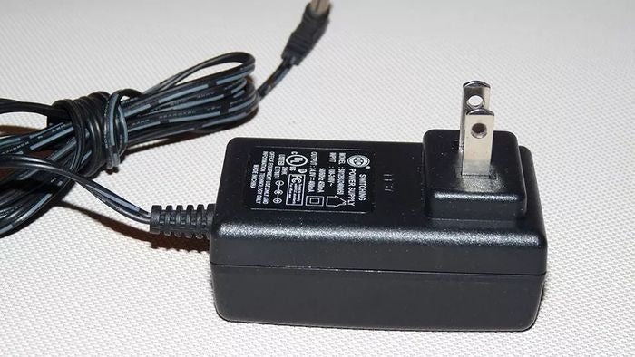 Switching Power Supply Adapter S012BU2400050 24V 400mA - a black wall-plug power adapter with a fixed two-prong plug and an attached power cord.