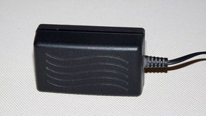Switching Power Supply Adapter S012BU2400050 24V 400mA - a black, rectangular power adapter with a wavy-line texture and an attached power cord.